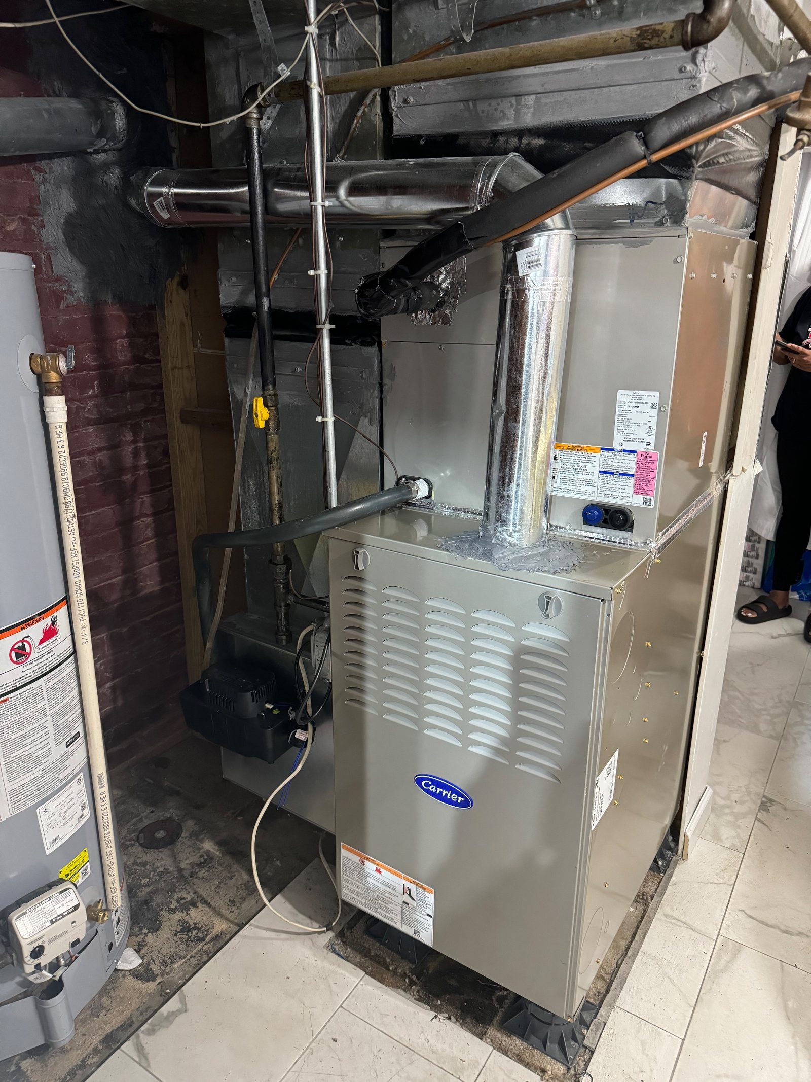 A gas furnace installed in a basement utility space